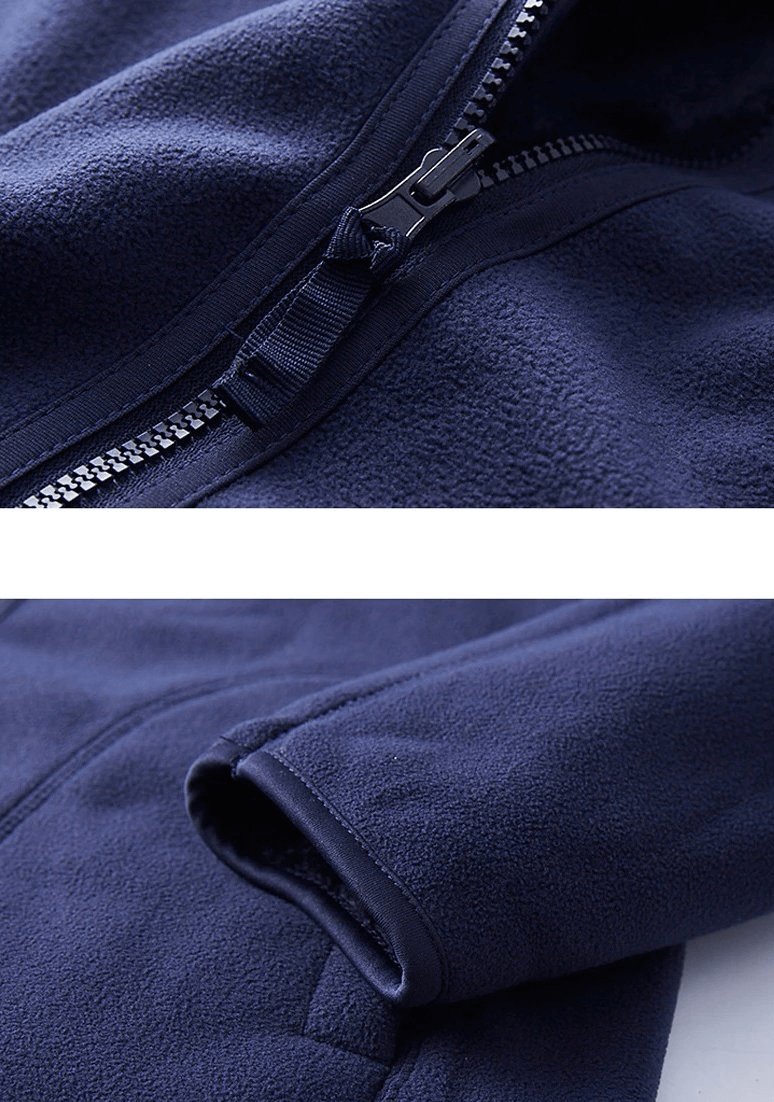Close-up of navy blue reversible women's fleece jacket with stylish zipper and hood, showcasing the detailed craftsmanship of the pullover.